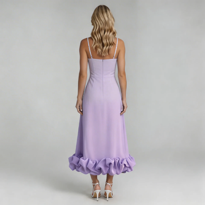 Back view of a woman in a light purple Hadley Ruffle Midi Dress, showcasing the fitted bodice and voluminous ruffled hem, worn with white heels.