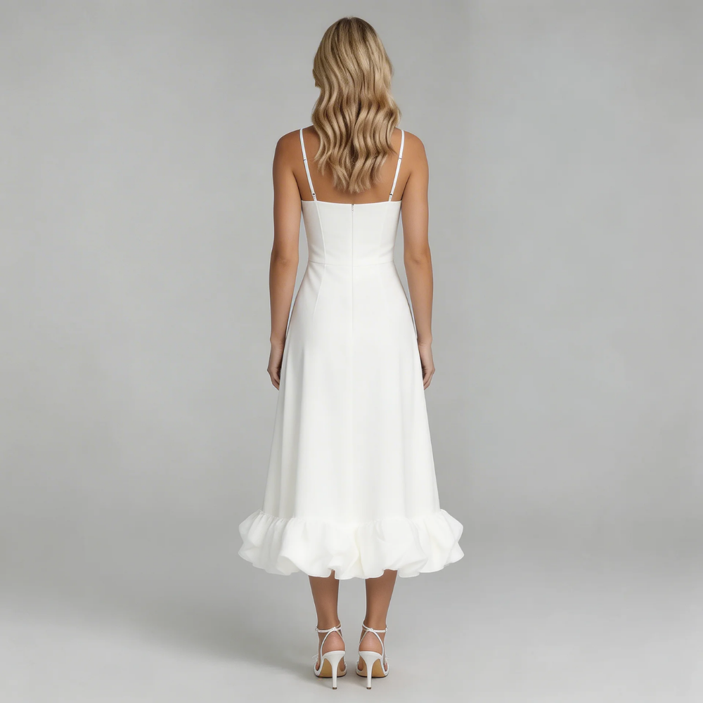 Back view of the white Hadley Ruffle Midi Dress, featuring the full, voluminous ruffled hem and delicate spaghetti straps.