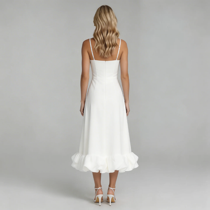 Back view of the white Hadley Ruffle Midi Dress, featuring the full, voluminous ruffled hem and delicate spaghetti straps.