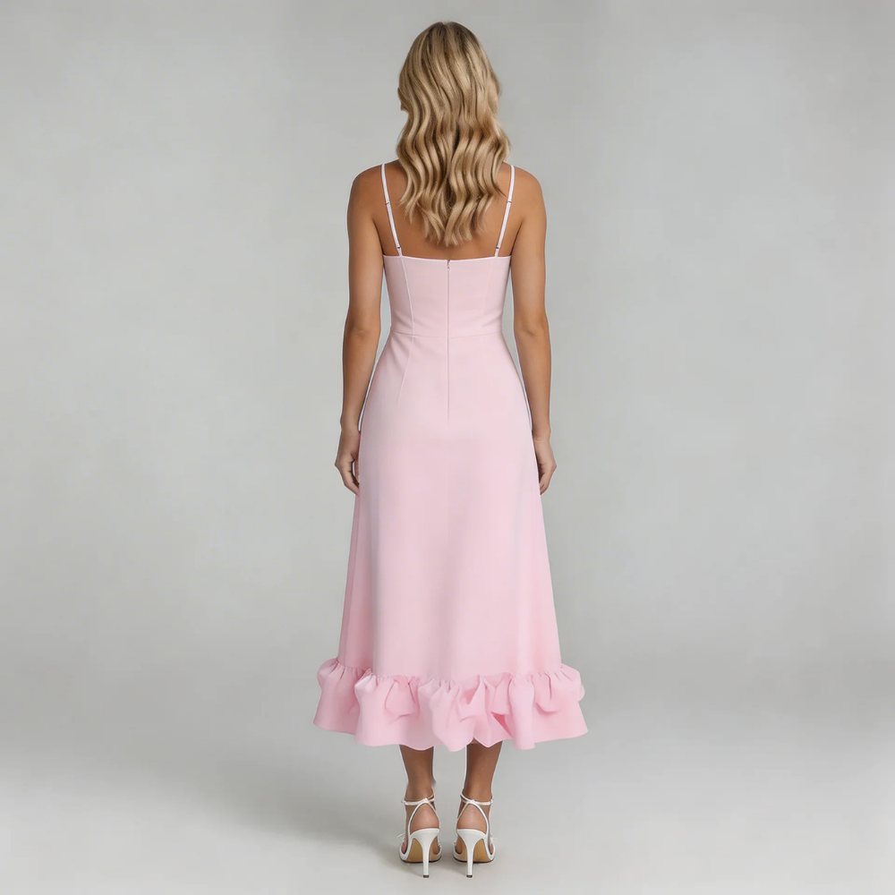 Back view of the pink Hadley Ruffle Midi Dress, displaying the subtle ruffled hem and thin white spaghetti straps.
