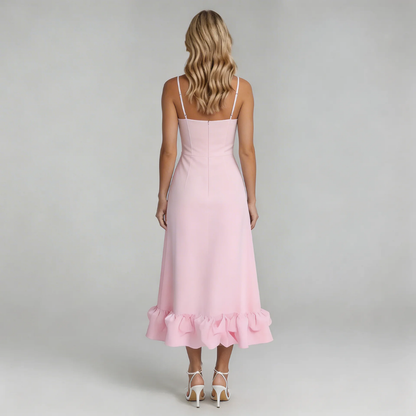 Back view of the pink Hadley Ruffle Midi Dress, displaying the subtle ruffled hem and thin white spaghetti straps.