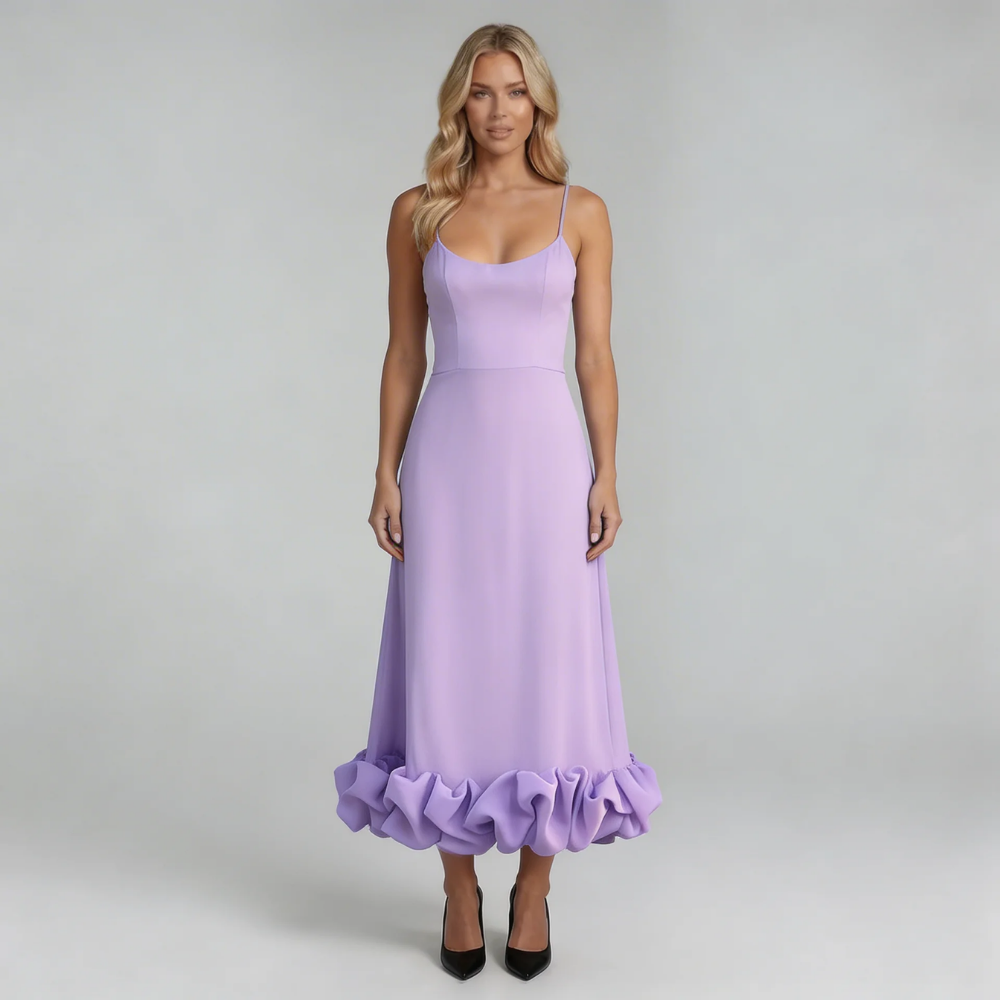 Purple midi dress with ruffled hem – displayed on model with natural movement in fabric.