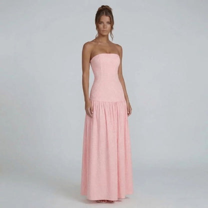Pink gingham strapless maxi dress — side view highlighting cinched bodice and flowing hemline.