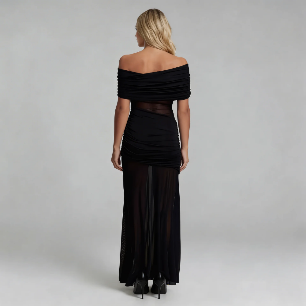Black mesh maxi dress — back view showing draped off-shoulder design and floor-length silhouette.