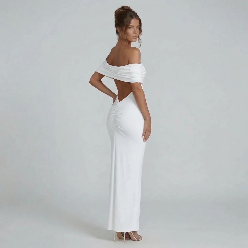 White off-shoulder ruched maxi dress with open back detail — side view showing gathered seam and flattering fit.