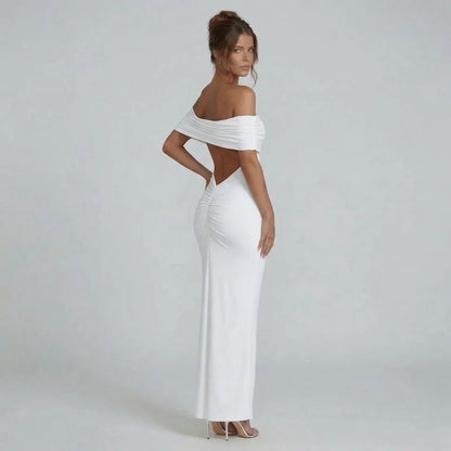 White off-shoulder ruched maxi dress with open back detail — side view showing gathered seam and flattering fit.