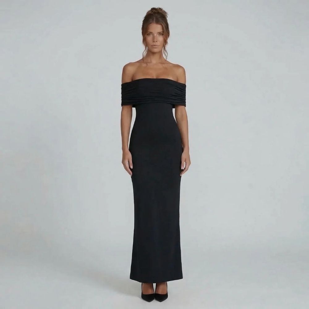 Black off-shoulder ruched maxi dress with elegant open back — front view styled with classic black heels.