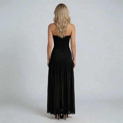 Black drop-waist maxi dress — back view with long gathered skirt