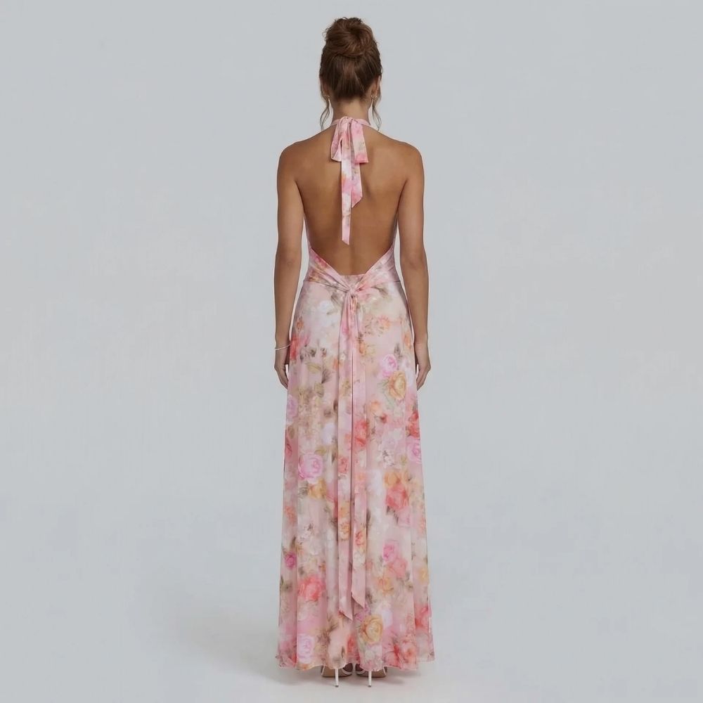 Blush floral halter maxi dress — back view showing open-back design with tied halter straps.