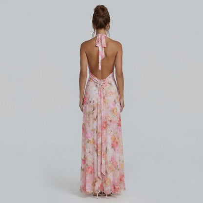 Blush floral halter maxi dress — back view showing open-back design with tied halter straps.