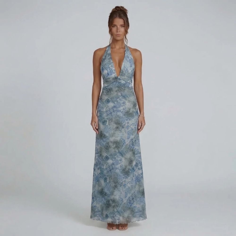 Blue printed halter maxi dress — front view featuring a graceful ruched waist and flowing skirt.