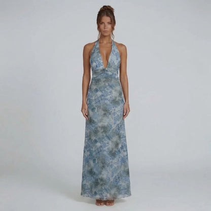 Blue printed halter maxi dress — front view featuring a graceful ruched waist and flowing skirt.