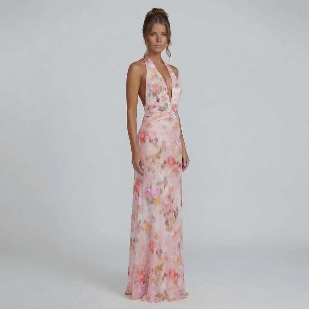 Blush floral halter maxi dress — front view showing flowing silhouette and flattering waistline.