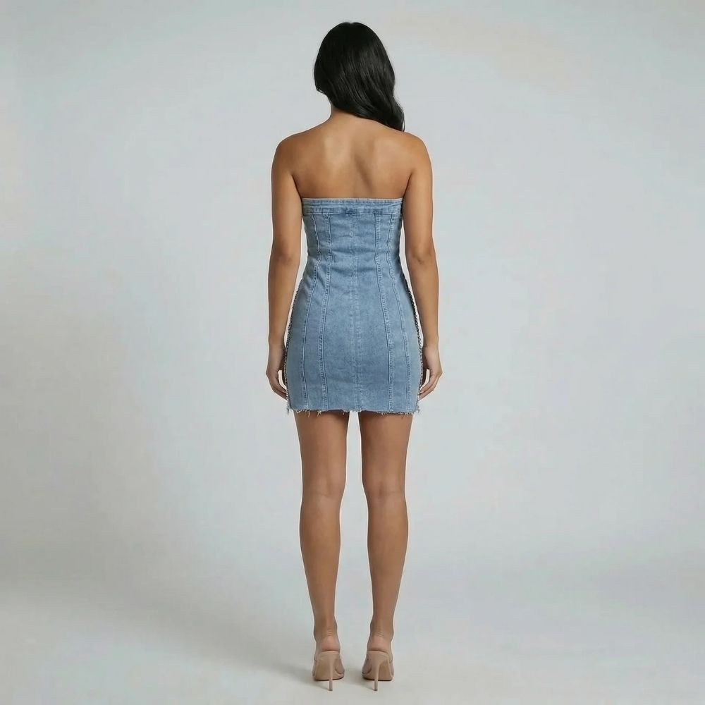Blue denim strapless mini dress — back view showing vertical seams and frayed hem.