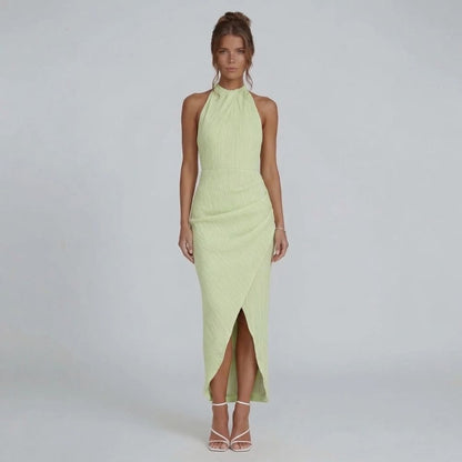 Green pleated maxi dress with halter neckline — front view showing wrap-effect skirt.