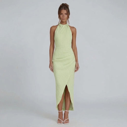 Green pleated maxi dress with halter neckline — front view showing wrap-effect skirt.