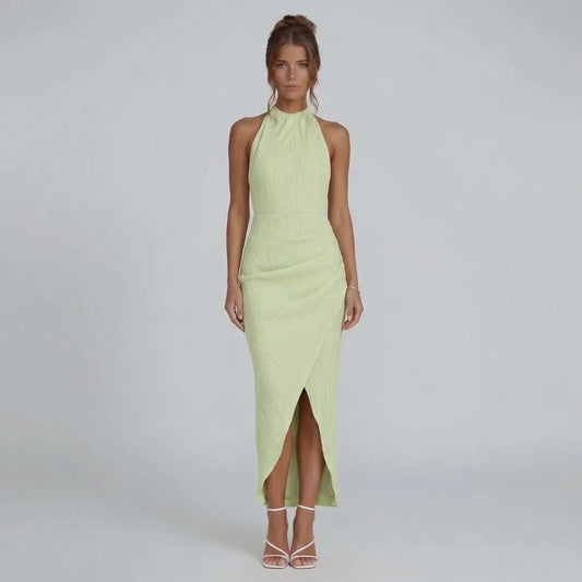 Green pleated maxi dress with halter neckline — front view showing wrap-effect skirt.