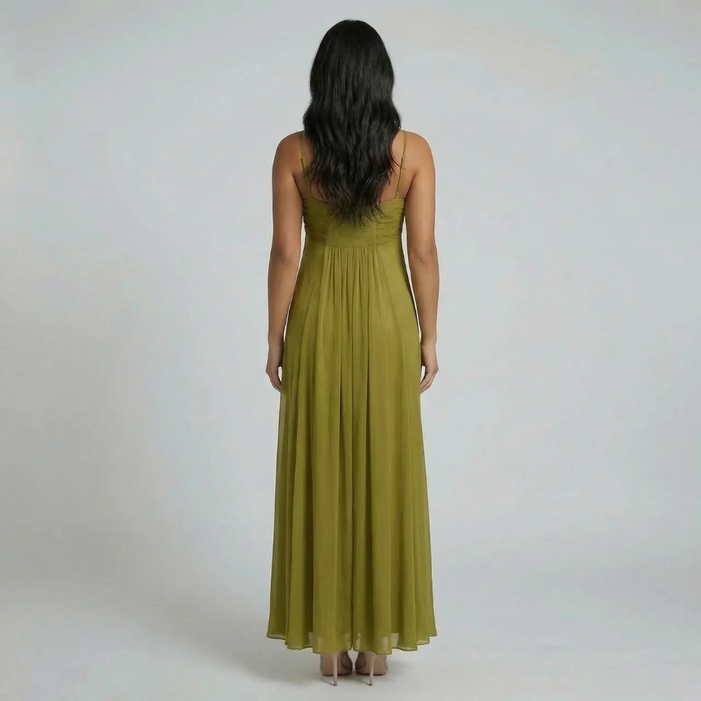 Green ruched maxi dress showing smocked back panel — back view of dress.