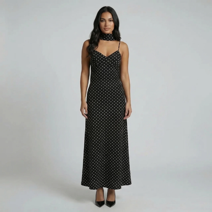 Black polka-dot maxi dress with scarf-neck detail — front view showing flowing skirt