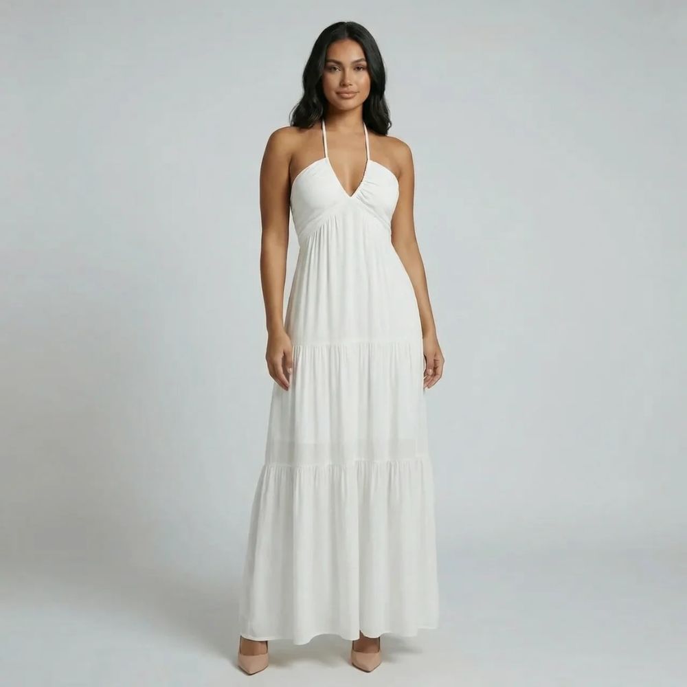 White tiered maxi dress — side view displaying open back and cascading skirt tiers.