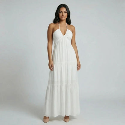 White tiered maxi dress — side view displaying open back and cascading skirt tiers.