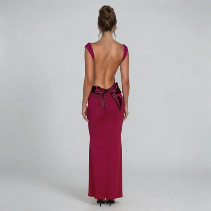 Red bow-back maxi dress showcasing a full open-back design and oversized bow — back view.