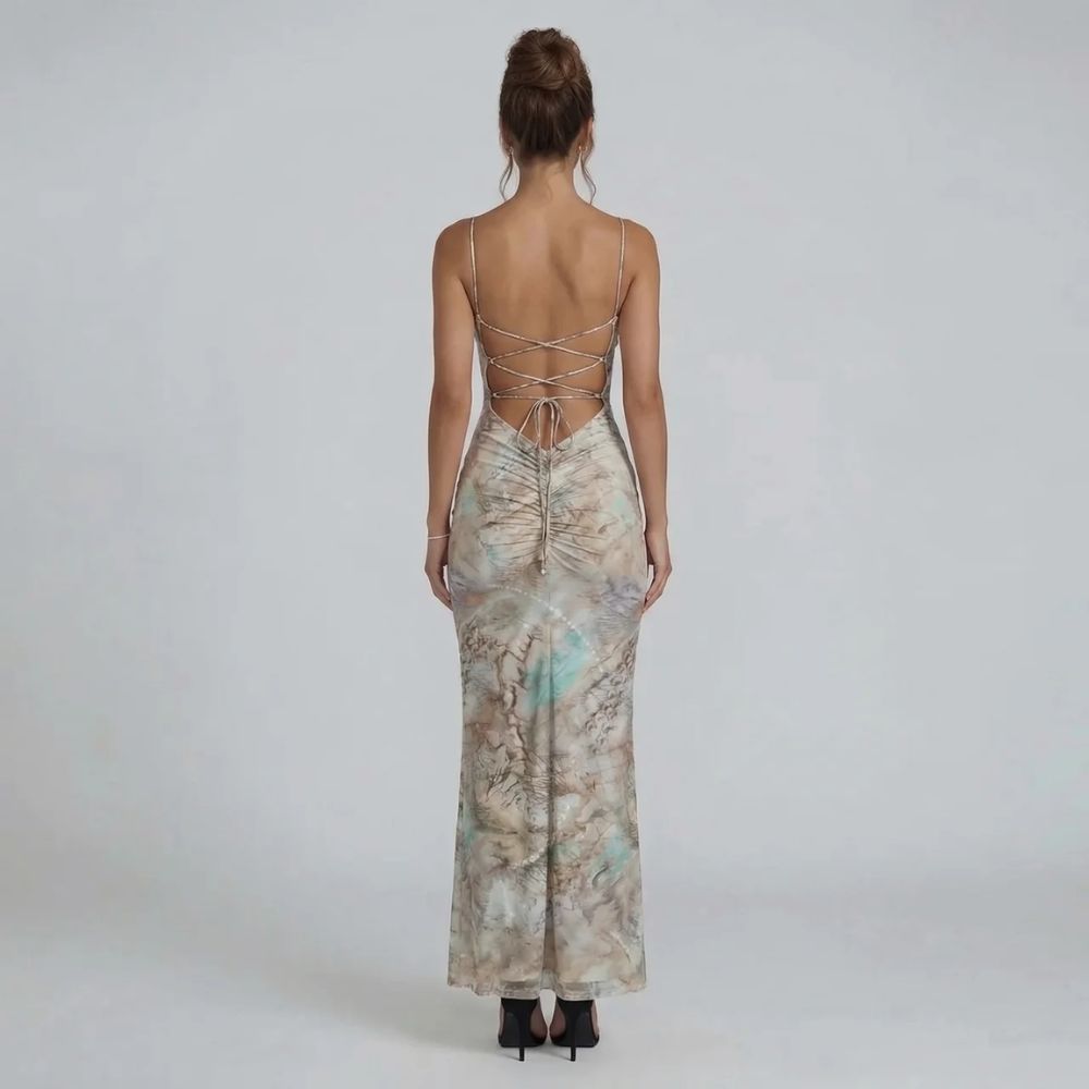 Beige marble print maxi dress with halter neckline — back view highlighting lace-up detail and body-chain accents.