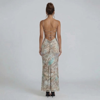 Beige marble print maxi dress with halter neckline — back view highlighting lace-up detail and body-chain accents.