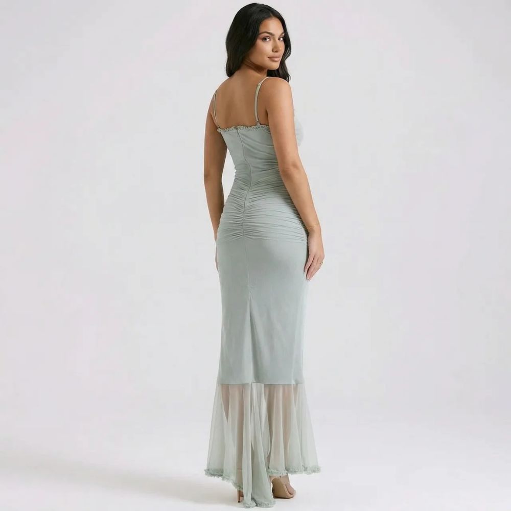 Green cutout maxi dress with ruched back and sheer overlay — back view