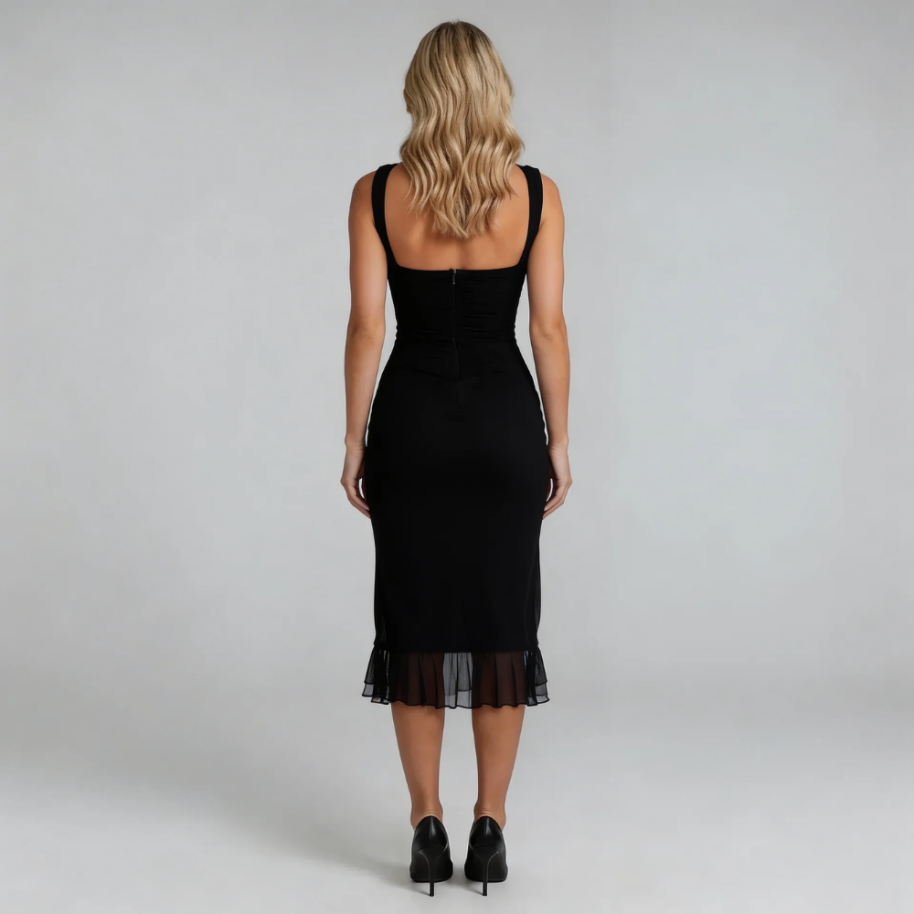 Black ruched midi dress with asymmetric hem — back view featuring zip closure