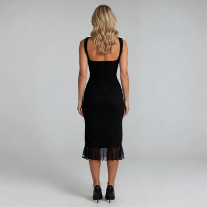 Black ruched midi dress with asymmetric hem — back view featuring zip closure