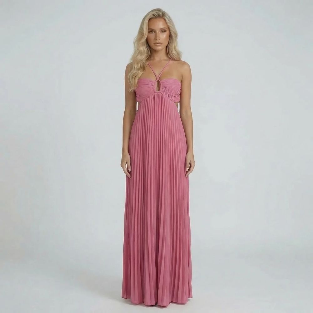 Pink pleated maxi dress with ruched bodice and halter straps, front view.