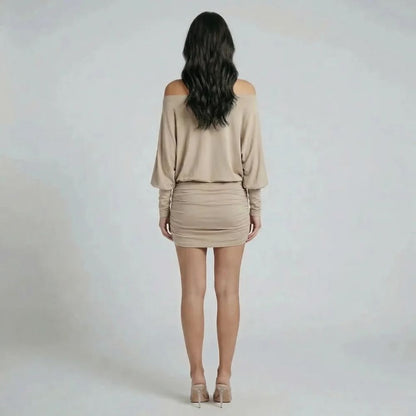 Beige ruched mini dress with off-shoulder neckline — back view highlighting the ruching detail.