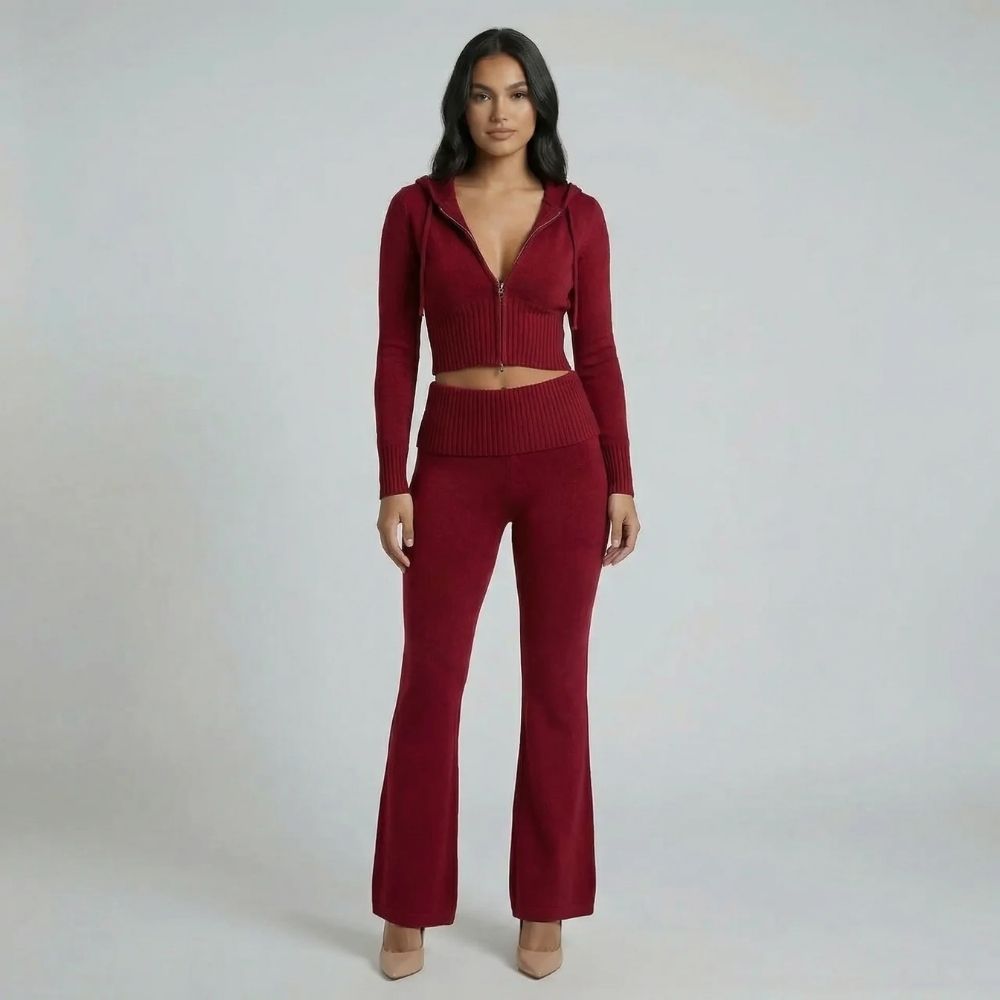 Rich red ribbed knit lounge set showcasing the cropped hoodie and flared pants — full-body angled view.