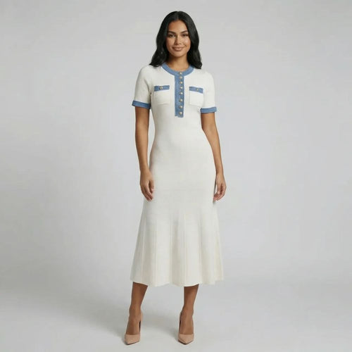 White knit maxi dress with blue trim and gold-tone buttons — front view showcasing structured details and flared hemline.