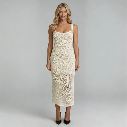 White crochet midi dress with 3D floral appliqué — front view highlighting intricate floral details and open-knit texture.