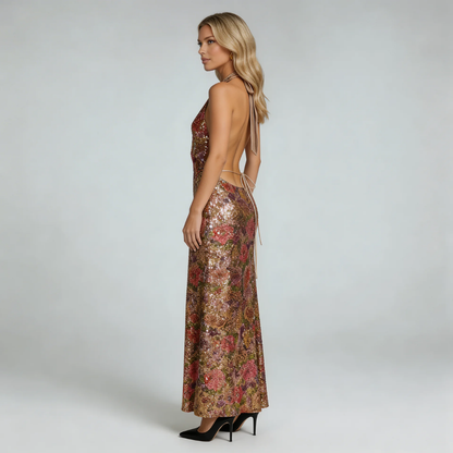 Gold floral sequin maxi dress — side view highlighting open back and halter tie detail.