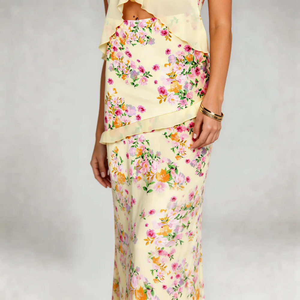 Ivory floral maxi set with floral print — close-up showing ruffle details on skirt and bandeau top.