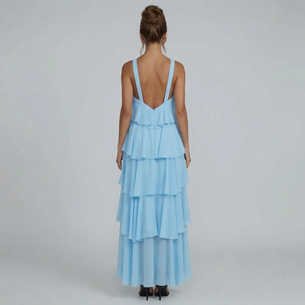 Rear view of the light blue ruffled maxi dress, showing the open back and cascading ruffles.
