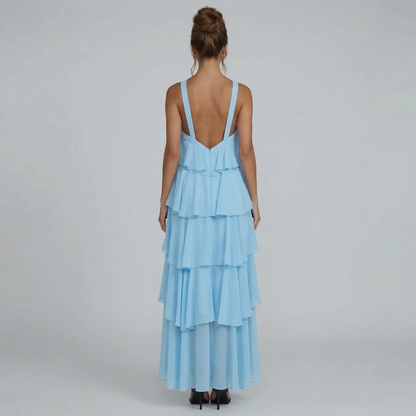 Rear view of the light blue ruffled maxi dress, showing the open back and cascading ruffles.