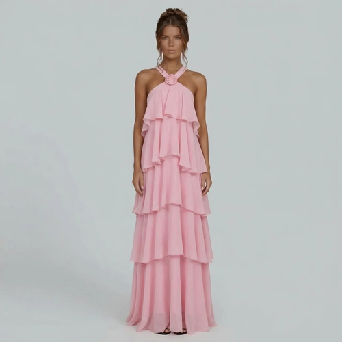Front view of a pink ruffled halter maxi dress with a floral detail on the neckline, flowing tiered skirt.