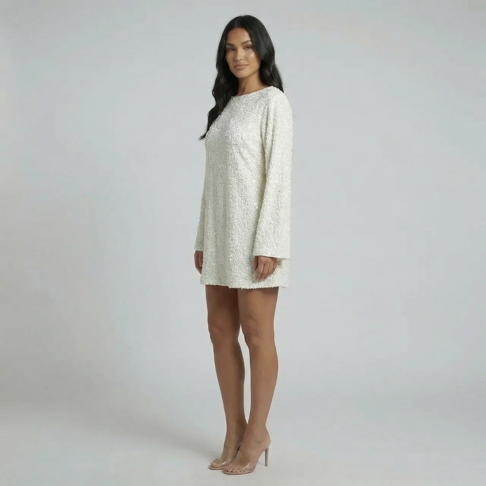 White sequin shift mini dress with oversized black bow detail — front view highlighting bateau neckline.