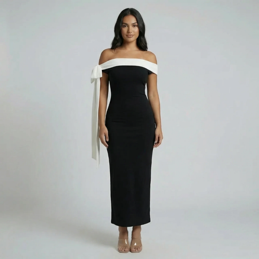 Black off-shoulder maxi dress with white bow detail — front view showing full-length sculpted silhouette.