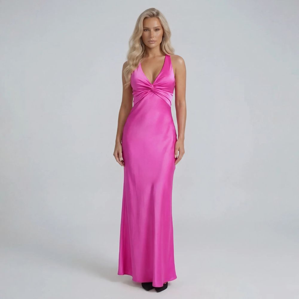 Pink twist-bust maxi dress with bow-tied open back — front view highlighting sculpted bodice and fluid skirt.