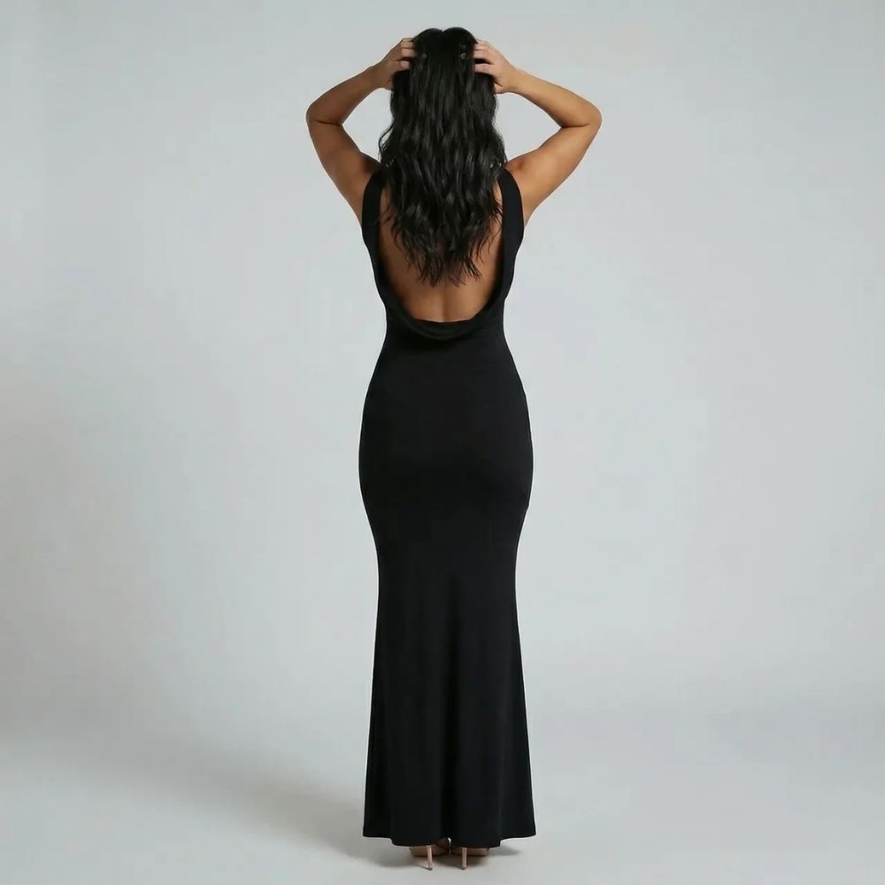 Black backless cowl maxi dress — back view showing low open back and streamlined silhouette
