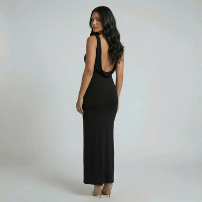 Black backless cowl maxi dress — side angle highlighting elegant neckline and body-skimming fit