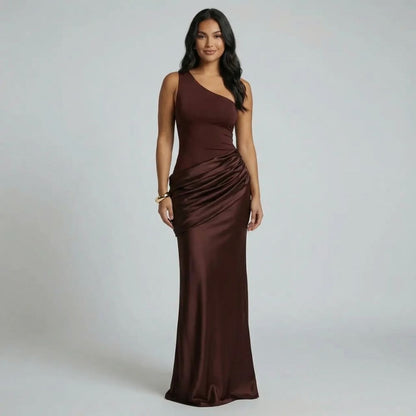 Dark brown draped maxi dress with one-shoulder detail — front view highlighting ruching and elegant full-length skirt.