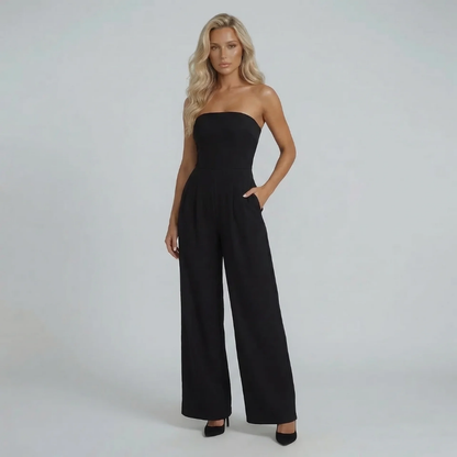 Black wide-leg bandeau jumpsuit — front view featuring side pockets and flowing wide-leg design.