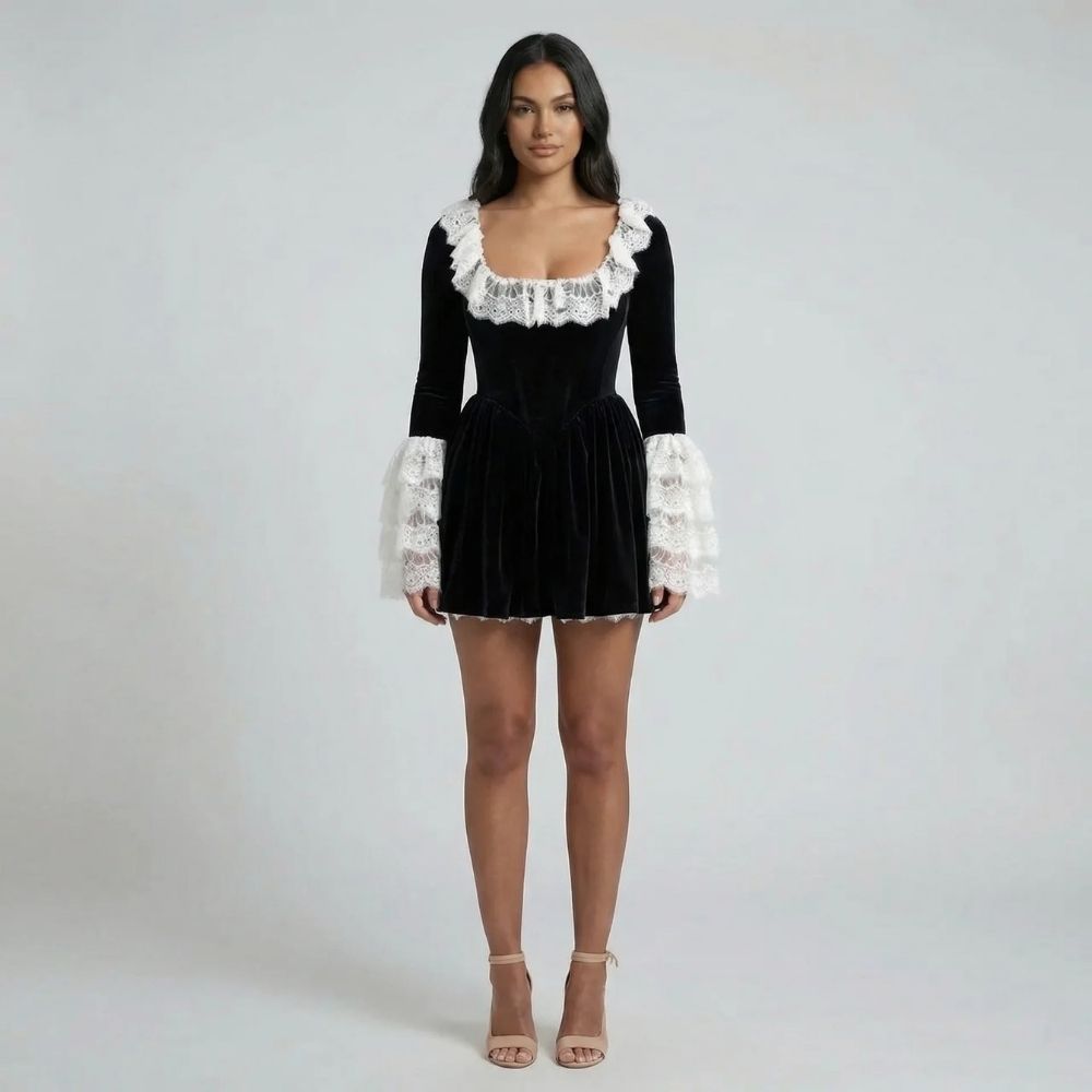 Black velvet mini dress with lace neckline and statement lace cuffs — front view of model.