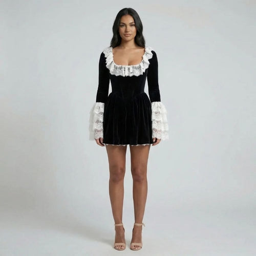 Black velvet mini dress with lace neckline and statement lace cuffs — front view of model.